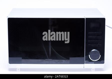metal and electrical microwave oven on white background Stock Photo
