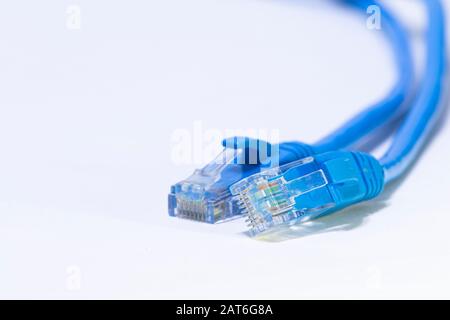 Blue ethernet cables for internet connection on white, isolated background. Stock Photo