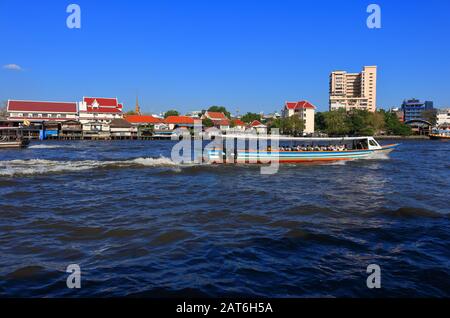 Bangkok, Thailand- January 28 2020: Traveling by boat to visit landmarks along Chao Phraya river is very popular for tourists Stock Photo