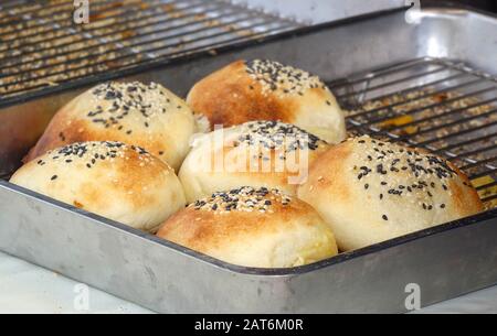 Freshly baked bread buns with sesame seeds Stock Photo