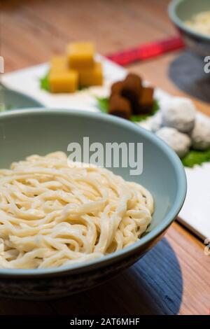 Chinese noodles with Beijing traditional pastry, such as yellow Pea jelly, Rolling donkey (glutinous rice rolls with sweet bean flour) on the table Stock Photo