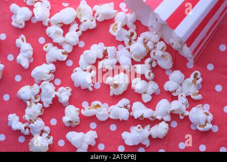 close up of popcorn and box on red background Stock Photo
