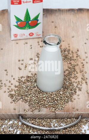 Vegan plant based milk alternatives. Vegan milk alternatives. Hemp seed milk with hemp seeds on a wooden board Stock Photo