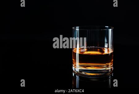 Elegant simple glass of luxury whisky against black background Stock Photo