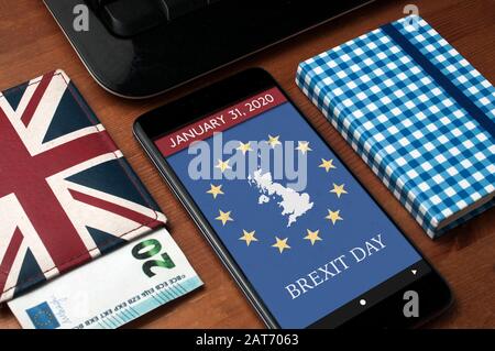 Brexit day concept: a smartphone on a wooden table with a calendar page that show the day in witch United Kingdom officialy left European Union Stock Photo
