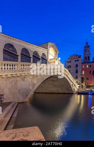Illuminated Rialto bridge in Venice at night Stock Photo - Alamy