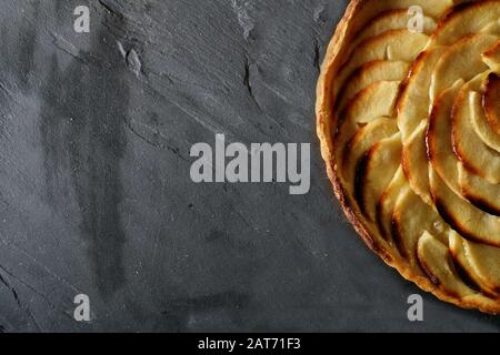 Top view of freshly baked apple tart on slate with text space Stock Photo