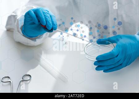cropped view of scientist doing dna test and sitting near illustration Stock Photo