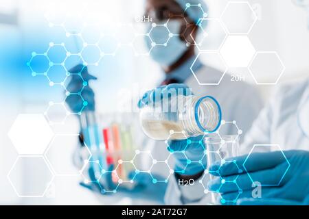 selective focus of multicultural biologist doing test with formulas illustration Stock Photo