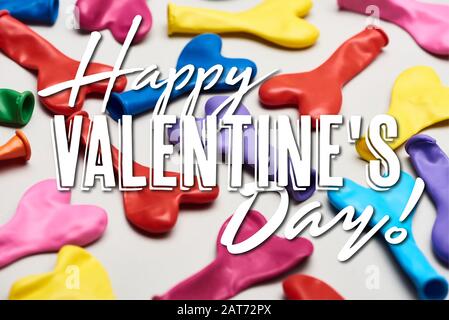 Colorful heart shaped balloons on grey background with happy valentines day illustration Stock Photo