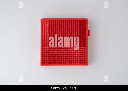 Red wireless speaker on grey background, top view Stock Photo