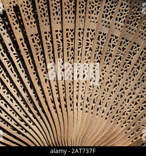 Folding fan. Wooden fan. Women's fan. Stock Photo