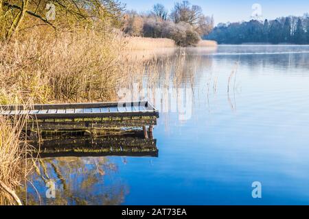 A cold, sunny winter's morning on Coate Water in Swindon. Stock Photo