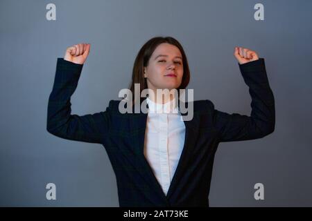 Confident and determined woman flexing muscles imagine has a powerful arm  with big biceps. Girl showing her strength, positive face expression.  Person Stock Photo - Alamy