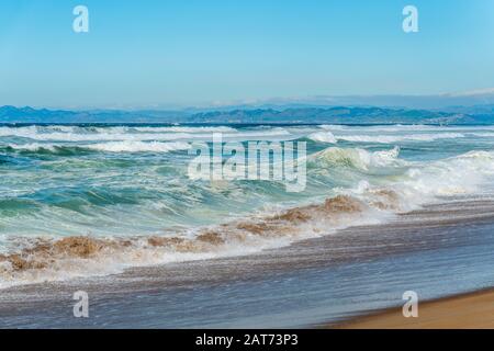 Beautiful seascape. Blue waves breaking on the shore. Stock Photo
