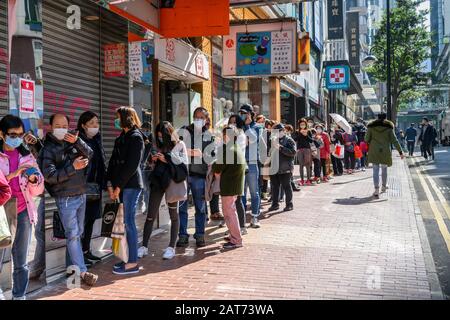 Hong Kong. 31st Jan, 2020. Hundreds of people queue to buy surgical masks at a Bonjour Cosmetics stores in Causeway Bay Hong Kong.  There is a shortage of face masks in the city and people often line up for hours in hopes of purchasing some at inflated prices. Stock Photo