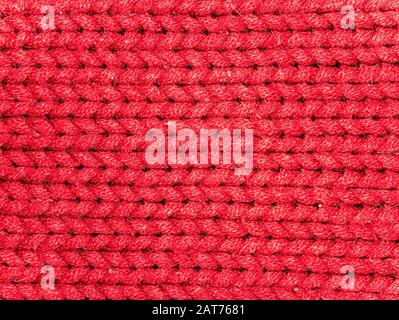 Texture of red woolen knitted fabric. Background image. Place for text. Stock Photo