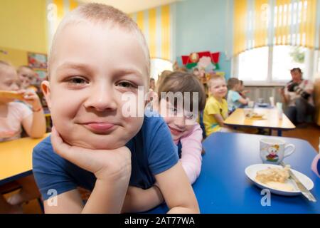 Belarus, the city of Gomil, April 25, 2019. Photoshoot in an institution. Close-up face of a child on a background of a kindergarten group Stock Photo
