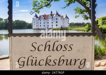 Sign with the German text 'Castle Glucksburg' in Schleswig-Holstein, Germany Stock Photo