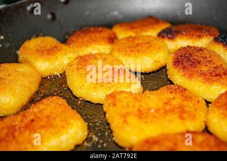 Chicken nuggets are fried in a pan. Close up Stock Photo