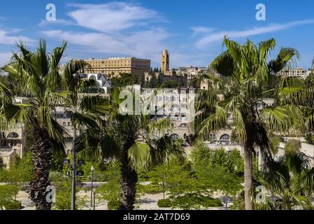 West Jerusalem development in morning sunshine seen through the palm trees Stock Photo