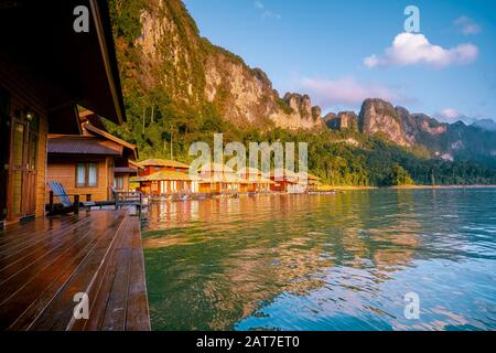 Wooden bungalows on tropical shore in the Chiew Lan Lake, Khao Sok national park, Thailand Stock Photo