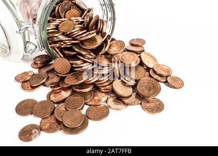 small change euro cent coins pouring out of glass jar isolated on white background, withdrawal of low denomination coins concept Stock Photo