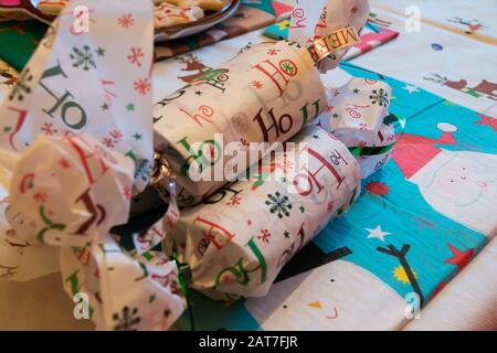 Christmas crackers on a decorated dinner table Stock Photo