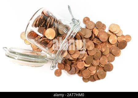 small change euro cent coins pouring out of glass jar isolated on white background, withdrawal of low denomination coins concept. Stock Photo