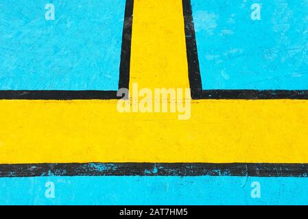 Black and yellow geometric lines are painted on a bright blue metal ship floor, serving as guides for passengers during emergency situations. Stock Photo