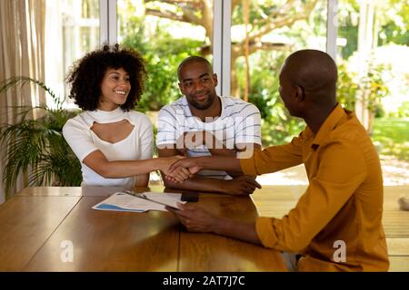 Young woman shaking hands with a financial adviser Stock Photo