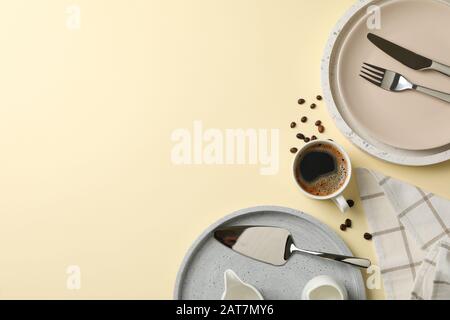 Table setting with cup of coffee on beige background, top view Stock Photo