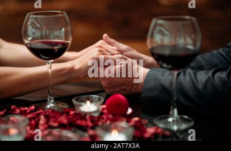 A couple having a romantic dinner in a elegance restaurant with beautiful decoration. Romance and Valentines day concept Stock Photo