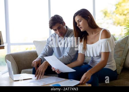 Young couple discussing on the sofa at home Stock Photo