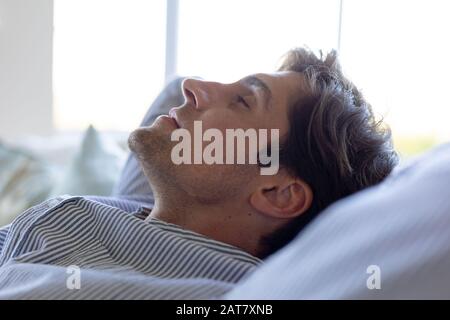 Young man relaxing on sofa at home Stock Photo