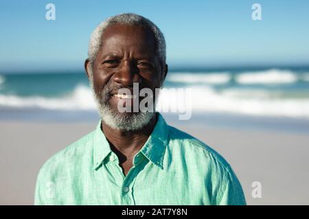 Old man smiling at the beach Stock Photo