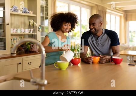 Happy young couple having breakfast in the kitchen Stock Photo