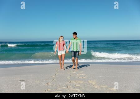 Young couple holding hands at the beach Stock Photo
