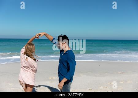 Young couple dancing at the beach Stock Photo