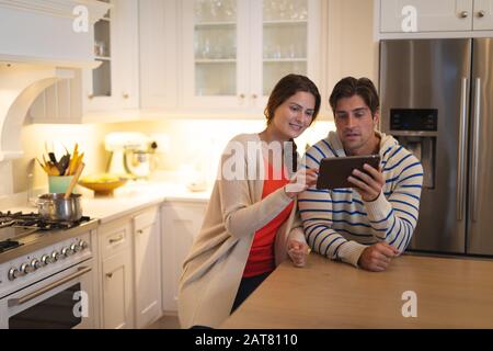 Young couple using tablet computer at home Stock Photo