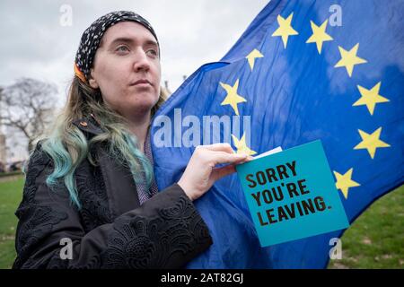 London, UK. 31 January 2020. A female anti-Brexit protester holds a card saying Sorry You’re Leaving at Parliament Square on Brexit Day Stock Photo