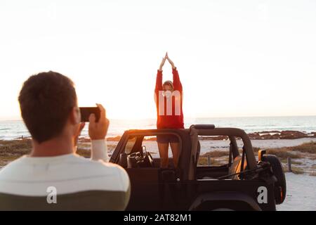 Couple taking photos in a car Stock Photo