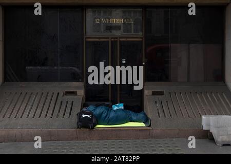 London, UK. 31 January 2020. On the day Britain formerly leaves the EU, a homeless person sleeps in a doorway outside number 12 Whitehall.