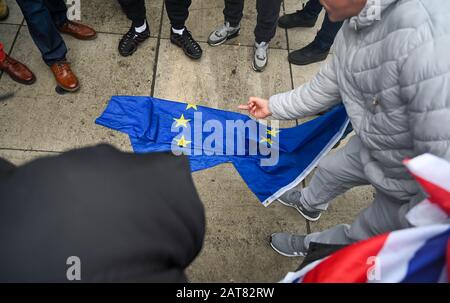 London UK 31st January 2020 - Brexit supporters start to celebrate and mock an EU flag in Parliament Square London as Britain prepares to leave the EU at 11pm later this evening 47 years after joining : Credit Simon Dack / Alamy Live News Stock Photo