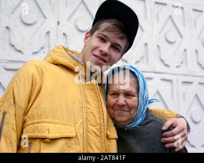 Kiev/Ukraine 01.15.2020 : grandson hugs his old grandmother. concept: family hug. Stock Photo