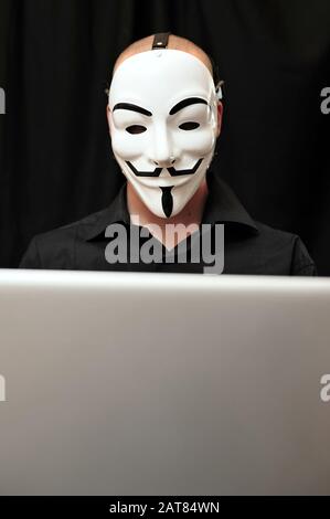 member of the Anonymous hacker group in front of the laptop Stock Photo ...