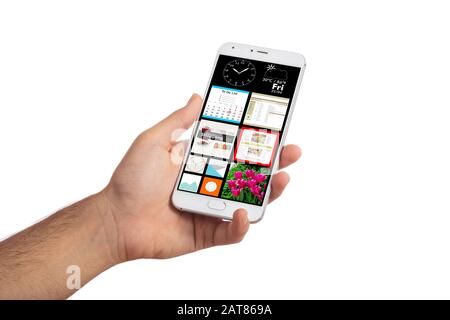 Smart phone app, hand holding mobile phone isolated against white background, applications on the screen Stock Photo