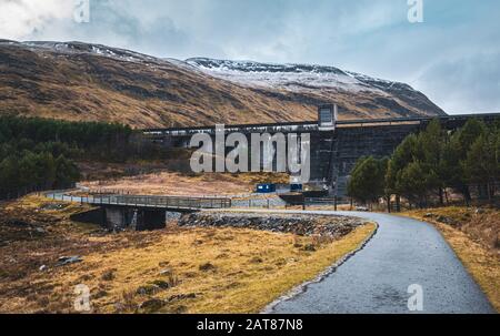Loch an Daimh dam in Glen Lyon on a winter day with snow on the surrounding hills. Perthshire, Scotland. Stock Photo