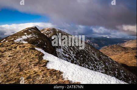 Ben Lomond ridge with snow on the frosted ground on a winter day. Stock Photo