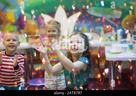 Children at the feast. Soap bubbles show. Children's party. Happy kids on holiday. Stock Photo